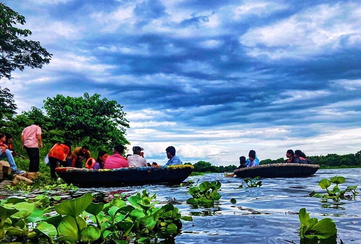 Group of guests enjoying a coracle ride on the Dandeli River near Magenta Resort