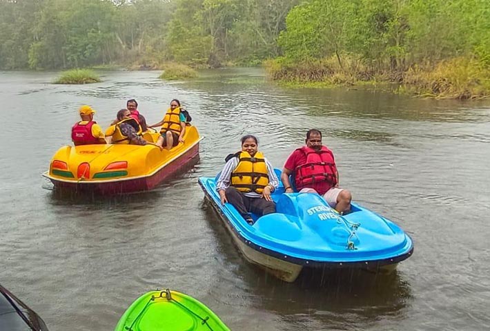 Group of adventurers river boating through the rapids near Magenta Resort in Dandeli