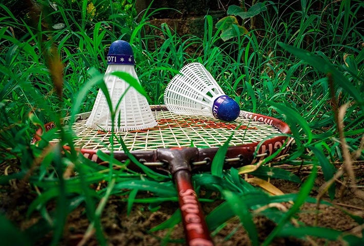 guests enjoying a game of badminton at Magenta Resort's sports area