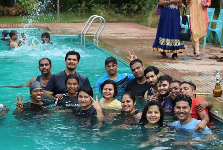 Guests splashing water and having fun during a rain dance at Magenta Resort